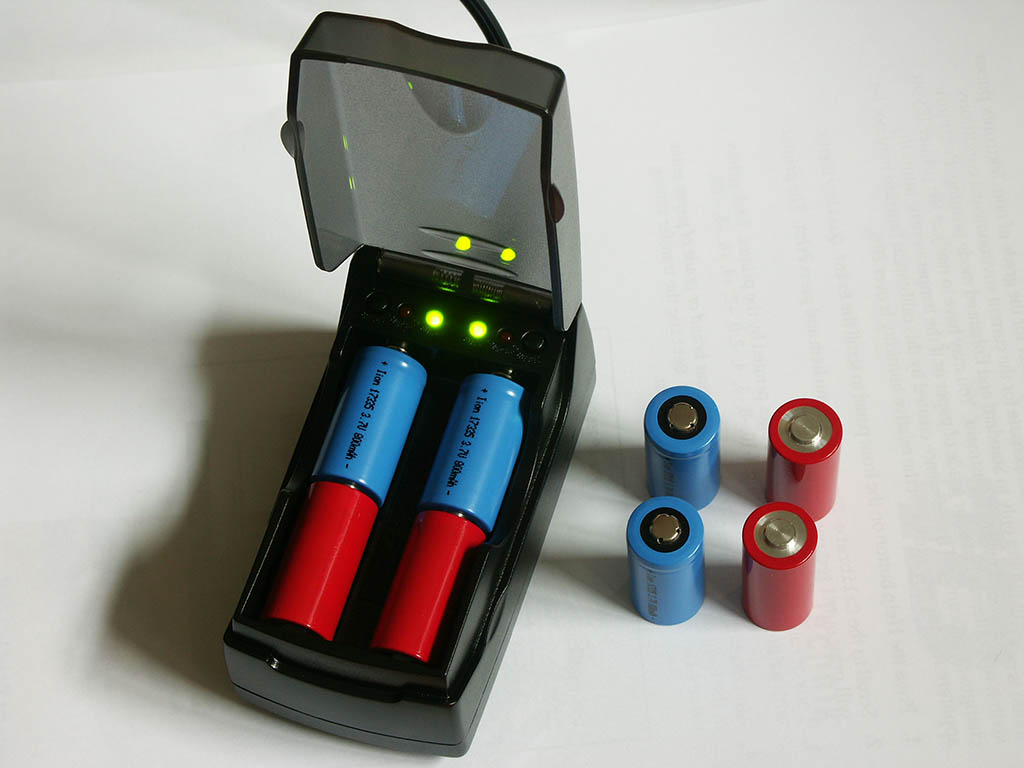 Pila Li-Ion charger with 17335-type Li-Ion cells and selfmade spacers (red)