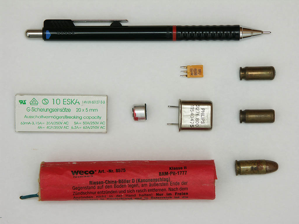 Retractable pencil, mains fuses, electret microphone capsule, ceramic filter, crystal, several different cartridges, fire cracker